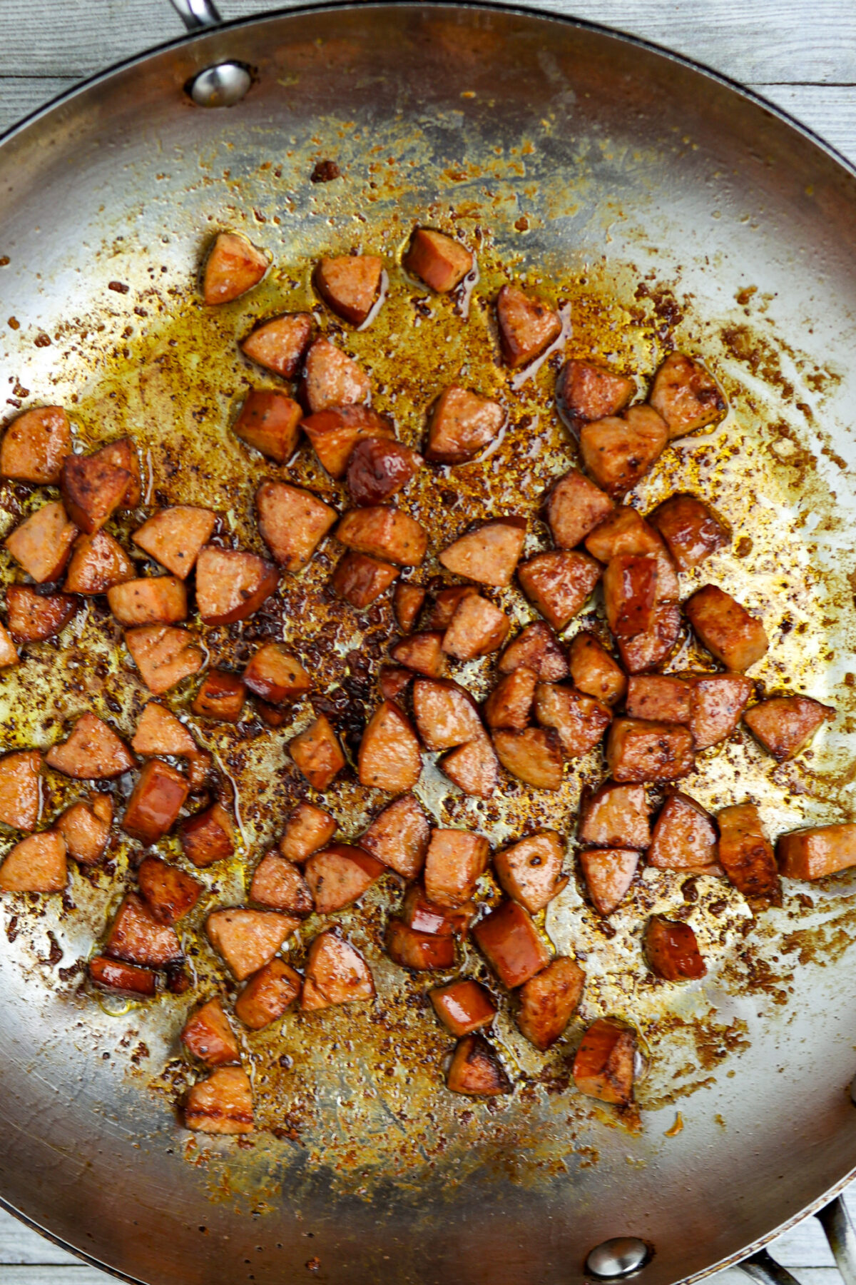 A pan of browned diced andouille sausage for shrimp grits.