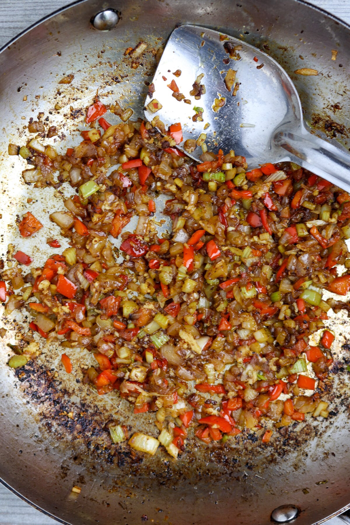 A pan of diced vegetables cooked in oil.