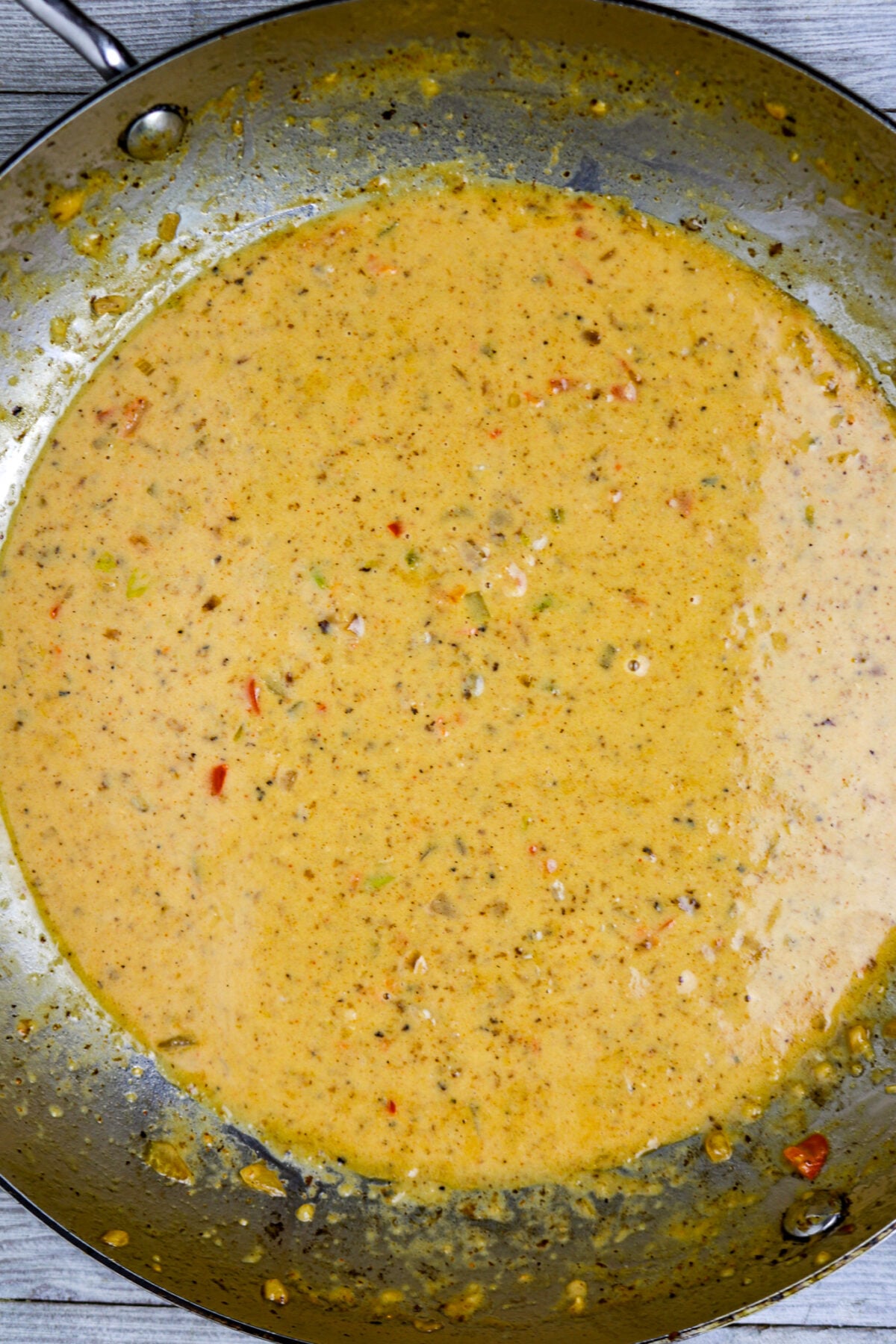 A pan with a yellow cream sauce in it.