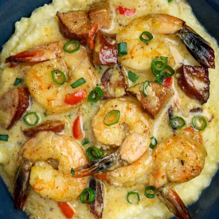 A blue bowl of shrimp and grits.