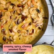 A pan of shrimp in a cream sauce with a pot of grits beside it.