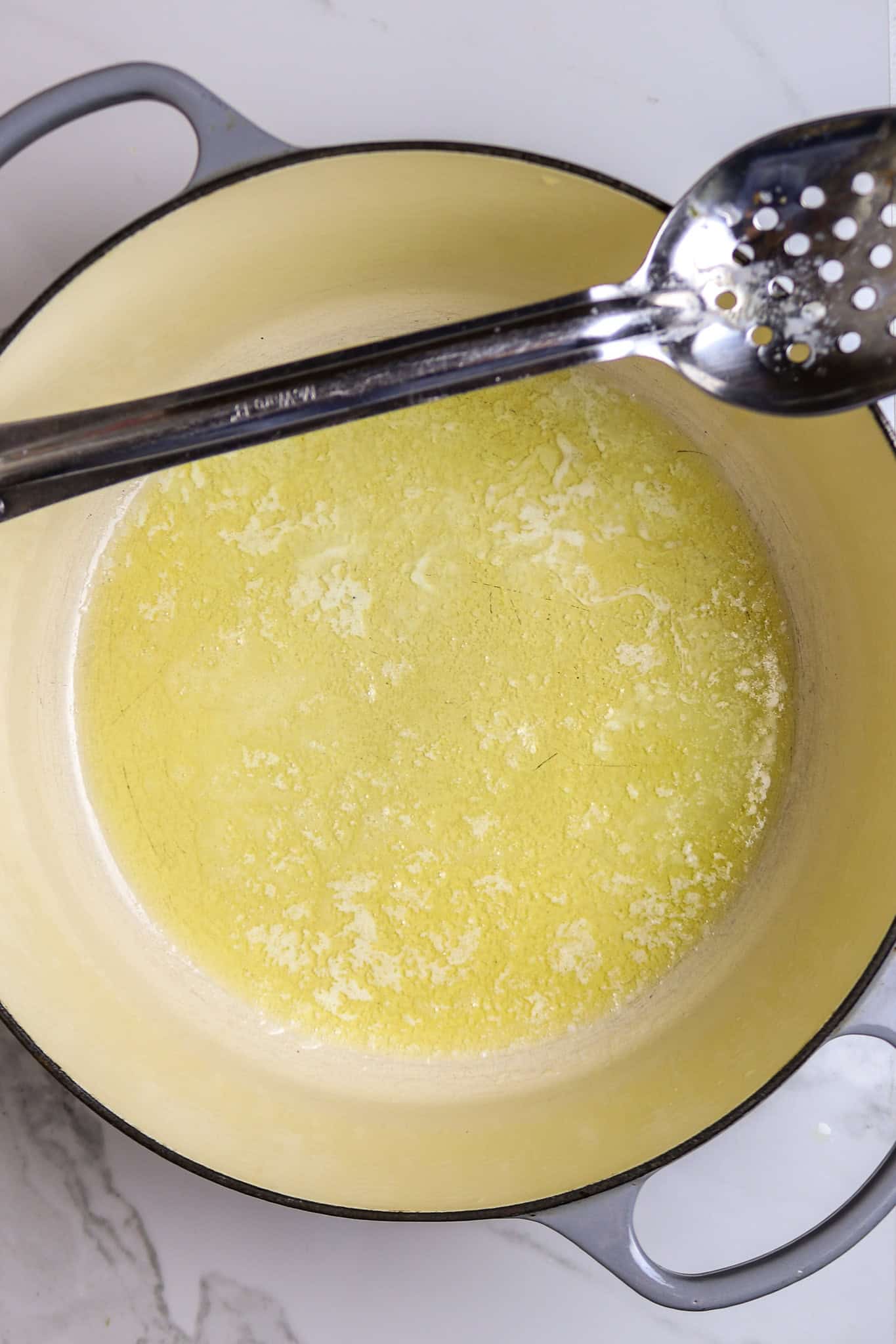 A pot of melted butter for crawfish pistolettes recipe.