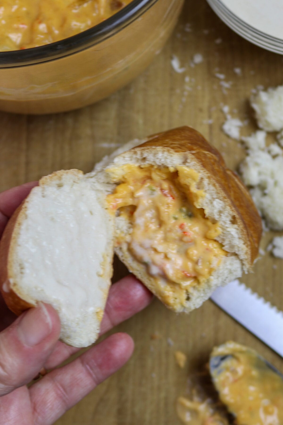 A roll cut in half and stuffed with crawfish sauce for crawfish pistolettes recipe.
