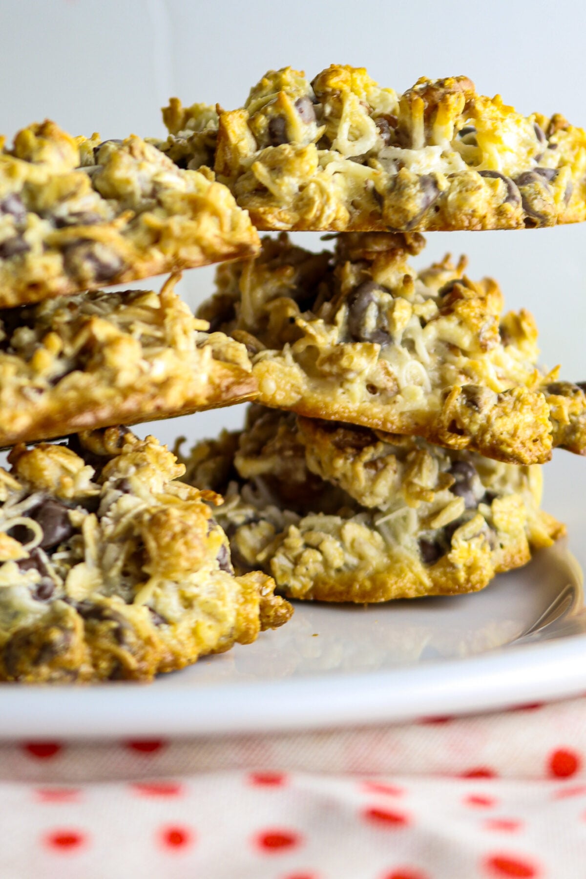 A stack of chocolate chip cookies on a green plate.