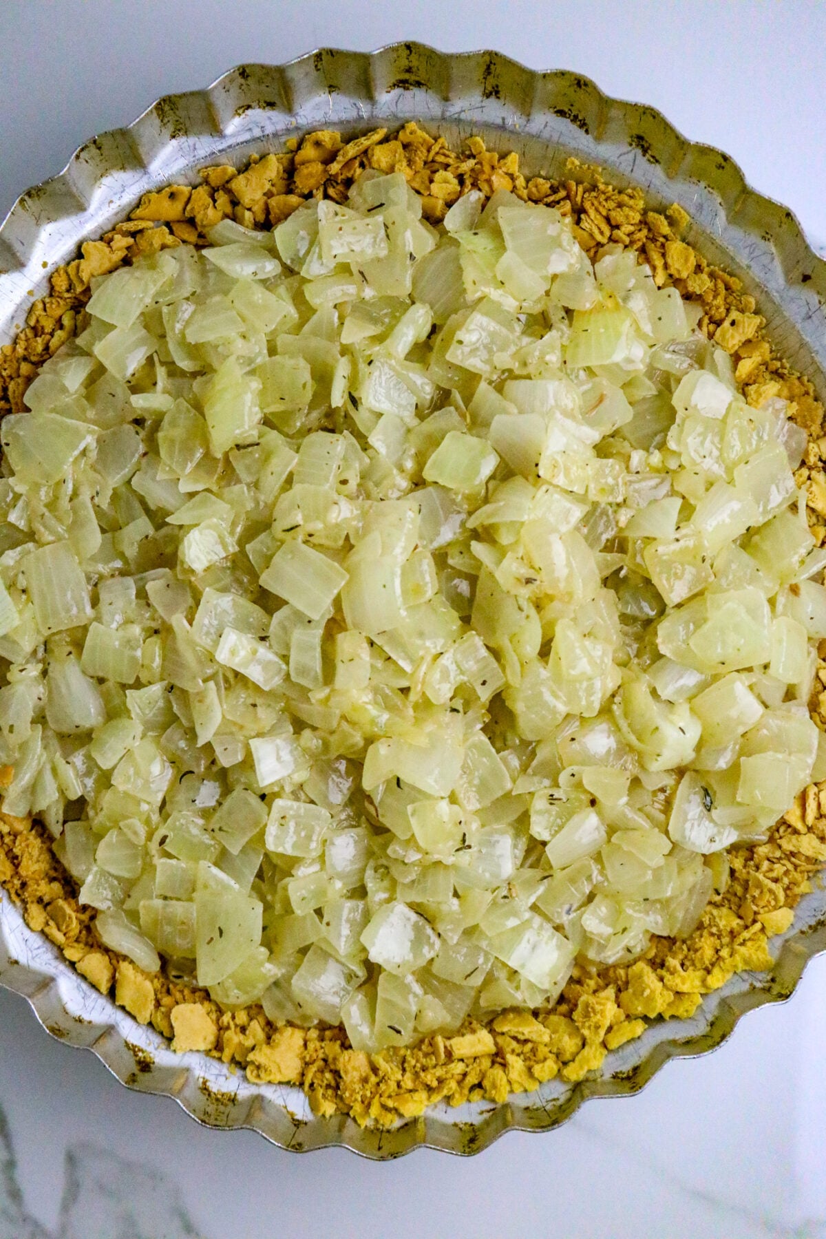 A cracker pie crust filled with cooked onions.
