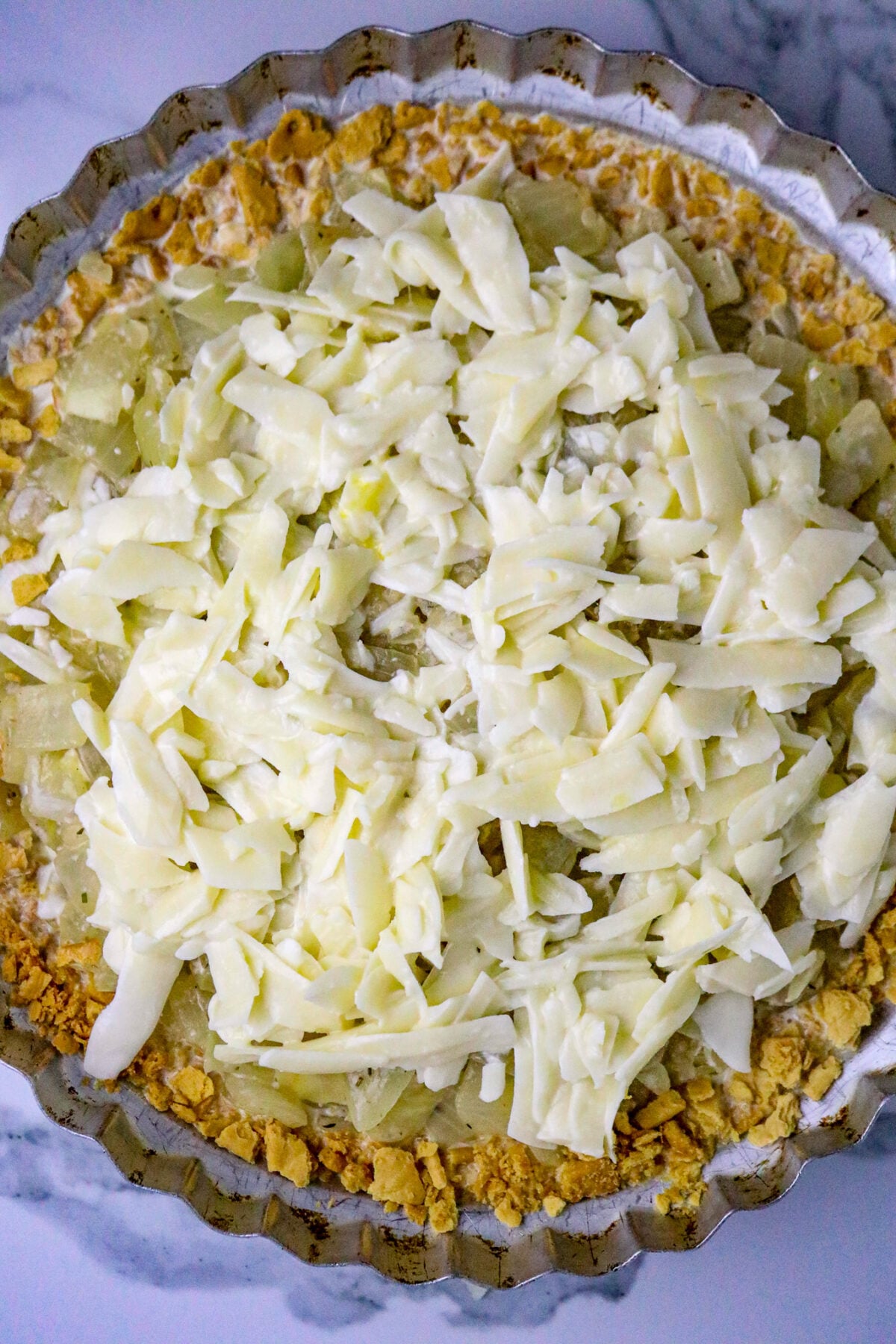 A cracker crumb pie filled with custard, onions and cheese.