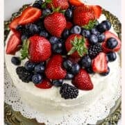 Pinterest of the Vanila Gentilly cake. a white cake covered with fresh berries.
