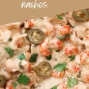 A Pinterest Pin of a plate of crawfish dip with lime slices.
