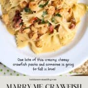A serving of Marry Me Crawfish which is bowtie pasta in a cream sauce with crawfish in a white pasta bowl for a Pinterest Pin.
